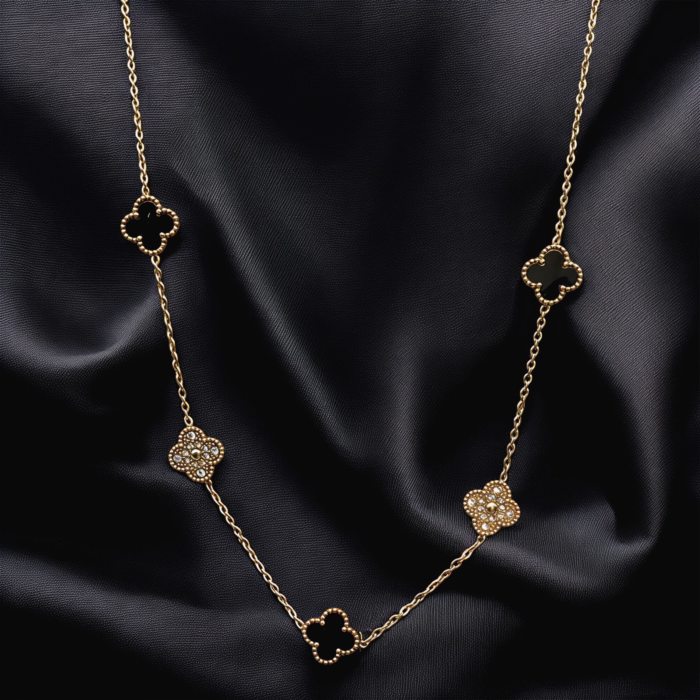 Elegant gold necklace with crystal-studded geometric charms